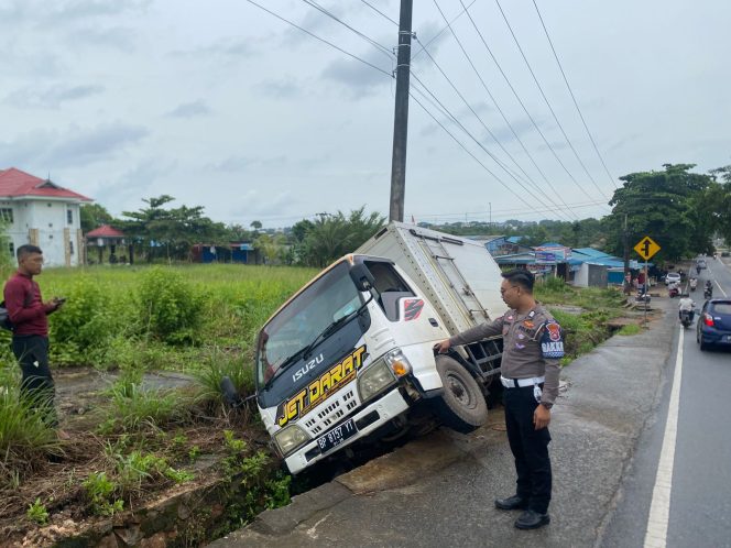
					Anggota Satlantas saat mengevakuasi  mobil box di Jalan Raja Haji Fisabilillah, Kilometer 8, Tanjungpinang, Selasa (15/7/2025). (Satlantas Tanjungpinang)